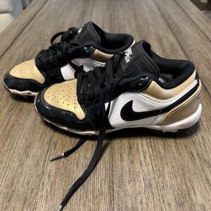 Nike Kids' Black, White, and Gold football cleats